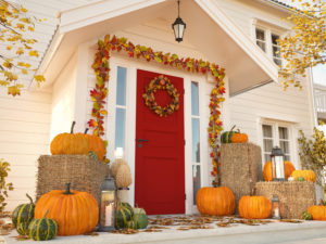 autumn decorated house with pumpkins and hay.