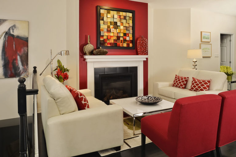 Fireplace and art work in a brightly colored, well decorated room