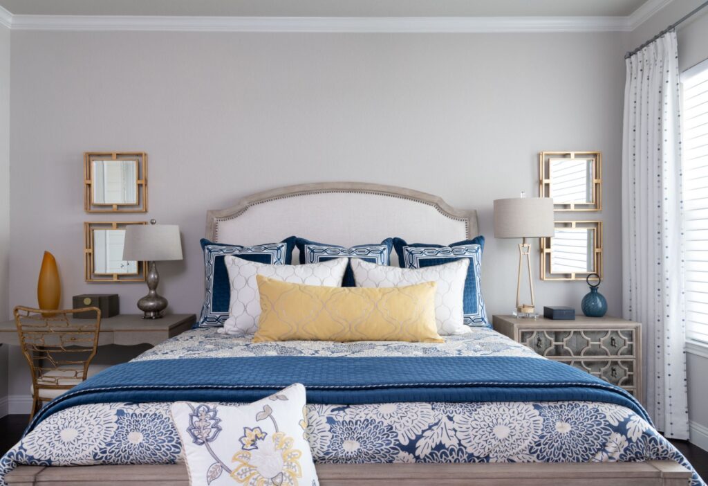 Blue white and yellow cushions on a bed